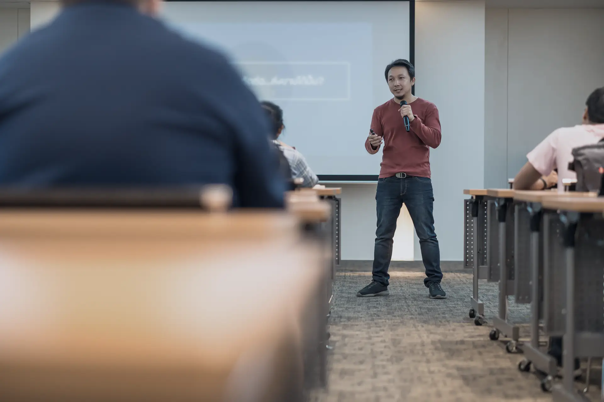 Presenter speaking to a seated audience during a business workforce readiness briefing